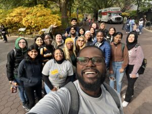 Diverse group of students grouped together for a photo outside during Transfer Student Week.